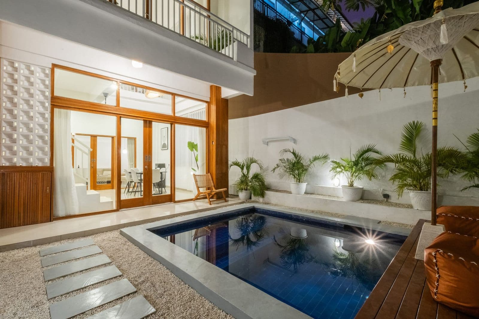 Villa courtyard and pool at dusk in Bali